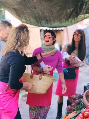 a group of women standing in front of a market at DAR AURORA in Marrakech