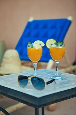 two glasses of orange juice and a pair of sunglasses at Riad Ambre et Jasmin in Marrakech