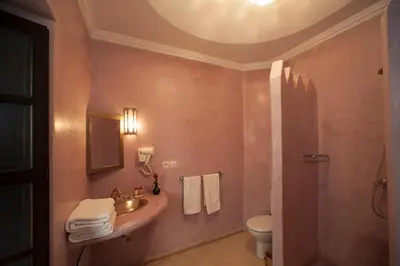 a bathroom with a sink and a toilet at Riad des trois palais in Marrakech