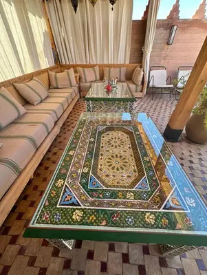 a living room with a couch and a table at Riad des trois palais in Marrakech