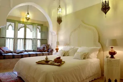 a bedroom with a large white bed and a couch at Riad Palacio De Las Especias in Marrakech