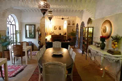 a living room with a table and chairs at Riad Palacio De Las Especias in Marrakech