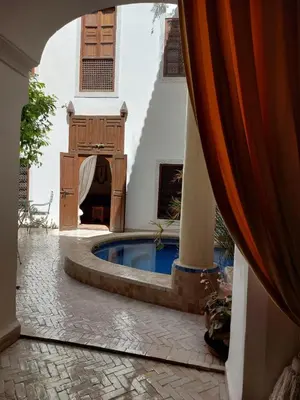 a courtyard with a swimming pool in a house at Riad Marélia in Marrakech