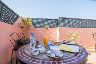a table with food and drinks on a patio at Riad Saad in Marrakech