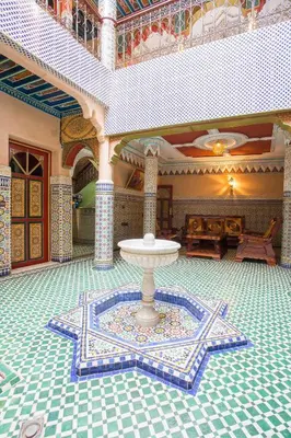 a room with a fountain in the middle of a building at Ryad Hamza in Marrakech