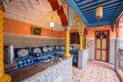a living room with a couch and a tv at Ryad Hamza in Marrakech