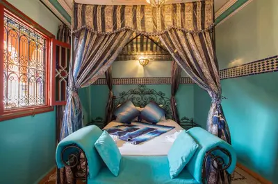 a bedroom with a bed with a canopy at Ryad Hamza in Marrakech