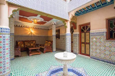 a room with a table in the middle of a building at Ryad Hamza in Marrakech