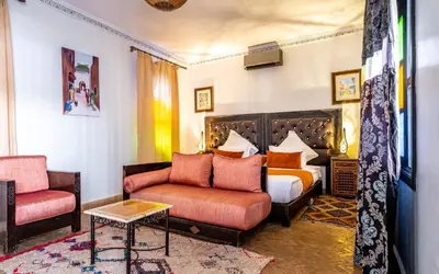 a hotel room with a bed and a couch at Kasbah Alili in Marrakech