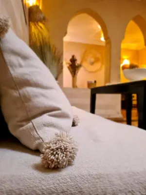a teddy bear sitting on a bed with a pillow at Riad Casa Sophia in Marrakech