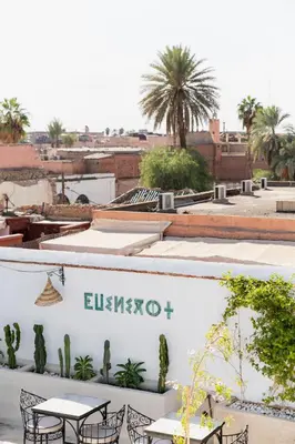 a view of a rooftop with tables and chairs at Riad Twilight in Marrakech