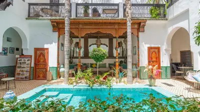 a house with a swimming pool in a courtyard at Riad Ghali Hotel & SPA in Marrakech