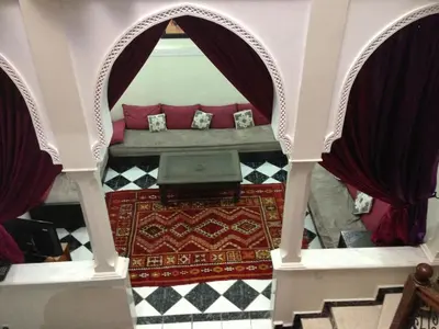 a room with a bed with a laptop on the floor at Riad Hicham in Marrakech in Marrakech