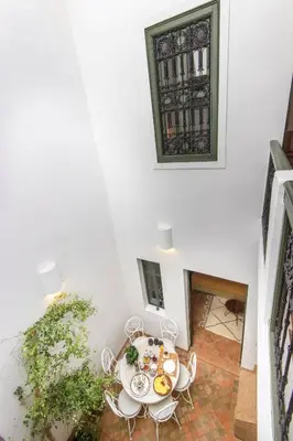 a room with a table and chairs and a window at Riad Myla - 2mn de Jemaa El Fna in Marrakech