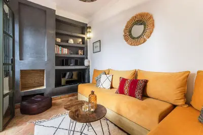 a living room with a couch and a table at Riad Myla - 2mn de Jemaa El Fna in Marrakech