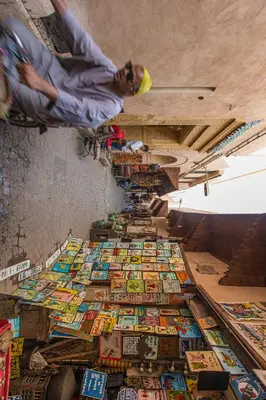 a man standing on top of a pile of books at Riad Myla - 2mn de Jemaa El Fna in Marrakech