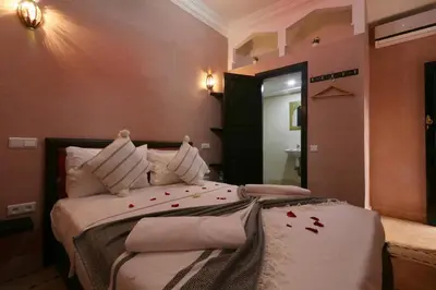 a bedroom with two beds with red leaves on them at Riad Elite in Marrakech