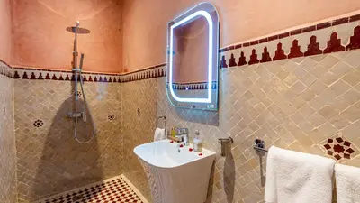 a bathroom with a sink and a shower at Riad Bab Tilila in Marrakech