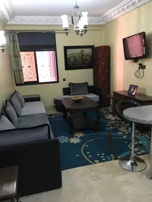 a living room with a couch and a table at pascal Apartment in Marrakech