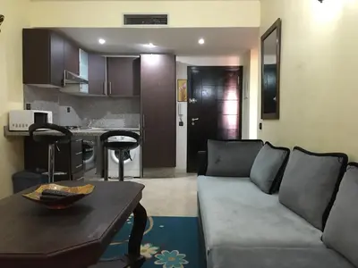 a living room with a couch and a table at pascal Apartment in Marrakech