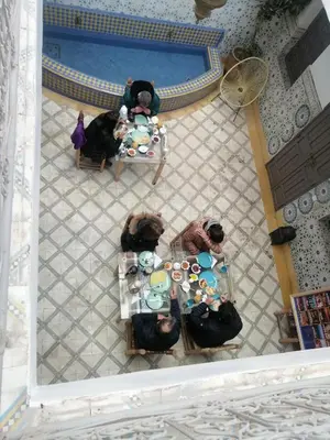 an overhead view of a group of people sitting at tables at Riad Papadou in Marrakech