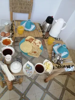 a table with breakfast foods and coffee on it at Riad Papadou in Marrakech
