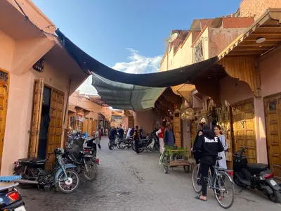 a group of people on bikes in an alley at Riad Papadou in Marrakech
