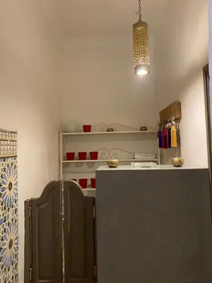 a small kitchen with a refrigerator and a light at Riad Papadou in Marrakech