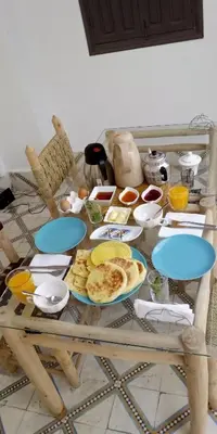 a table with plates of food on top of it at Riad Papadou in Marrakech