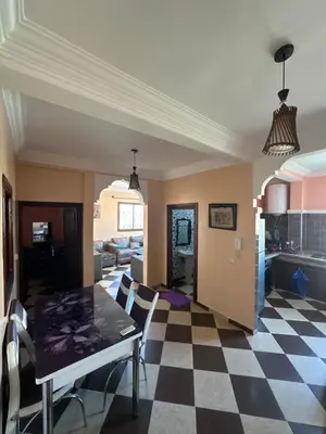 a kitchen and living room with a checkered floor at Marrakech Family appartements in Marrakech