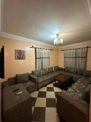 a living room with a couch and a table at Marrakech Family appartements in Marrakech