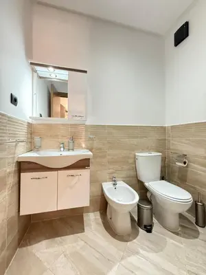 a bathroom with a sink and a toilet and a mirror at Appartement haut standing in Marrakech