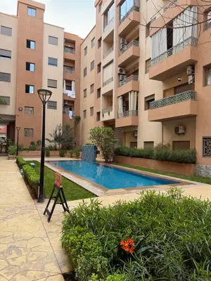 a swimming pool in front of a building at Appartement haut standing in Marrakech