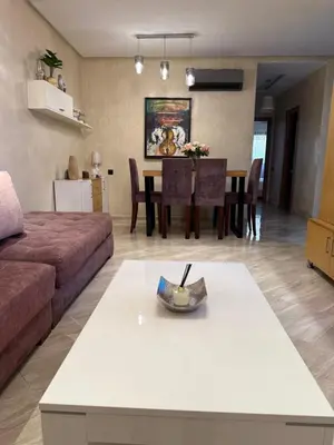 a living room with a couch and a table at Appartement haut standing in Marrakech