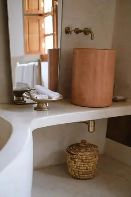 a bathroom counter with a sink and a mirror at Riad L'Atelier in Marrakech