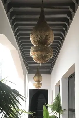 two chandeliers hanging from a ceiling in a room at Riad Bab aylen - Piscine Roof Top chauffée in Marrakech