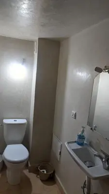 a bathroom with a toilet and a sink and a mirror at Riad Taziri in Marrakech