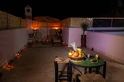 a table with a bowl of fruit on a patio at Riad Taziri in Marrakech