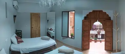 a small bedroom with a bed and a window at Riad Taziri in Marrakech