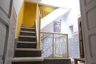 a staircase in a house with a gold railing at Hannah House Marrakech in Marrakech