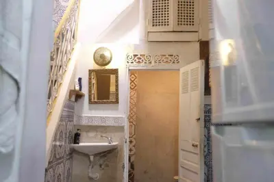 a small bathroom with a sink and a mirror at Hannah House Marrakech in Marrakech