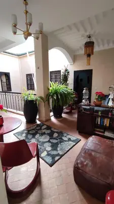 a living room with a couch and a rug at RIAD PÉNÉLOPE Marrakech in Marrakech