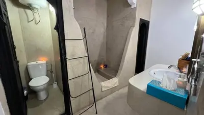 a bathroom with a toilet and a shower and a sink at RIAD PÉNÉLOPE Marrakech in Marrakech