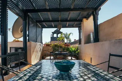 a patio with a table with a bowl on it at Riad Nomada Marrakech in Marrakech