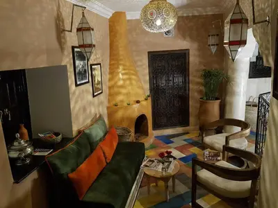 a living room with a couch and a table at Riad Bilkis Votre Maison Marrakech in Marrakech