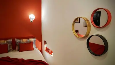 a bedroom with a bed and two mirrors on the wall at Riad Bilkis Votre Maison Marrakech in Marrakech