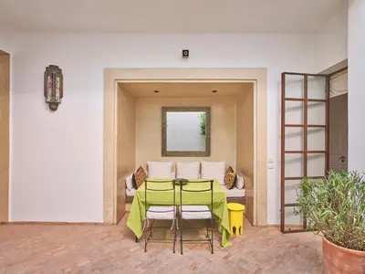 a table and chairs in a room with a couch at Riad Volubilis in Marrakech