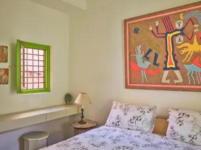a bedroom with a bed and a painting on the wall at Riad Volubilis in Marrakech