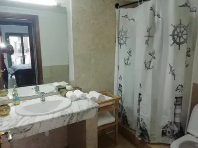 a bathroom with a sink and a shower curtain at appartment achwaq in Marrakech