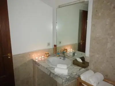 a bathroom with a sink and a large mirror at appartment achwaq in Marrakech